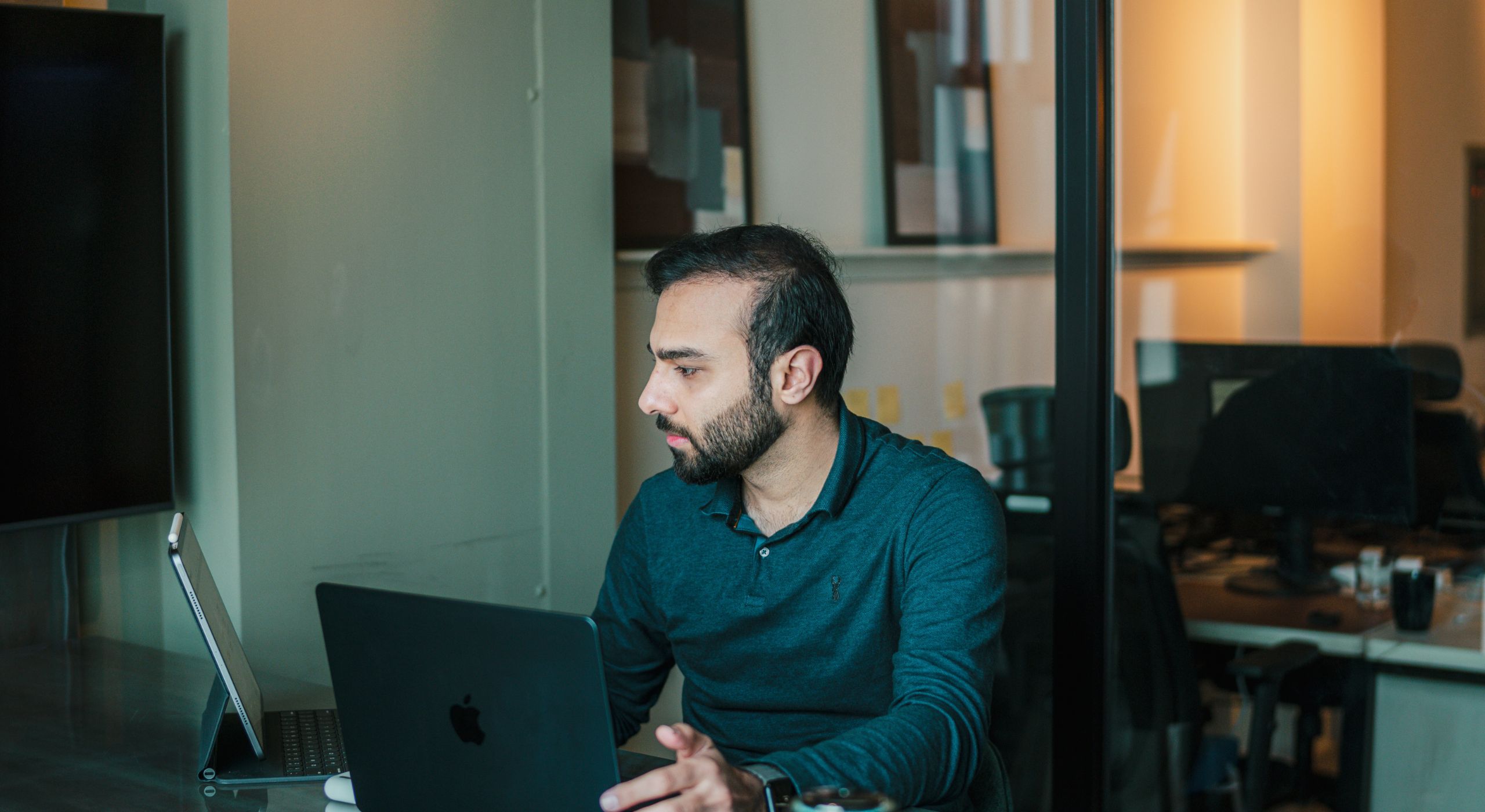 Three teammates talking in a lounge