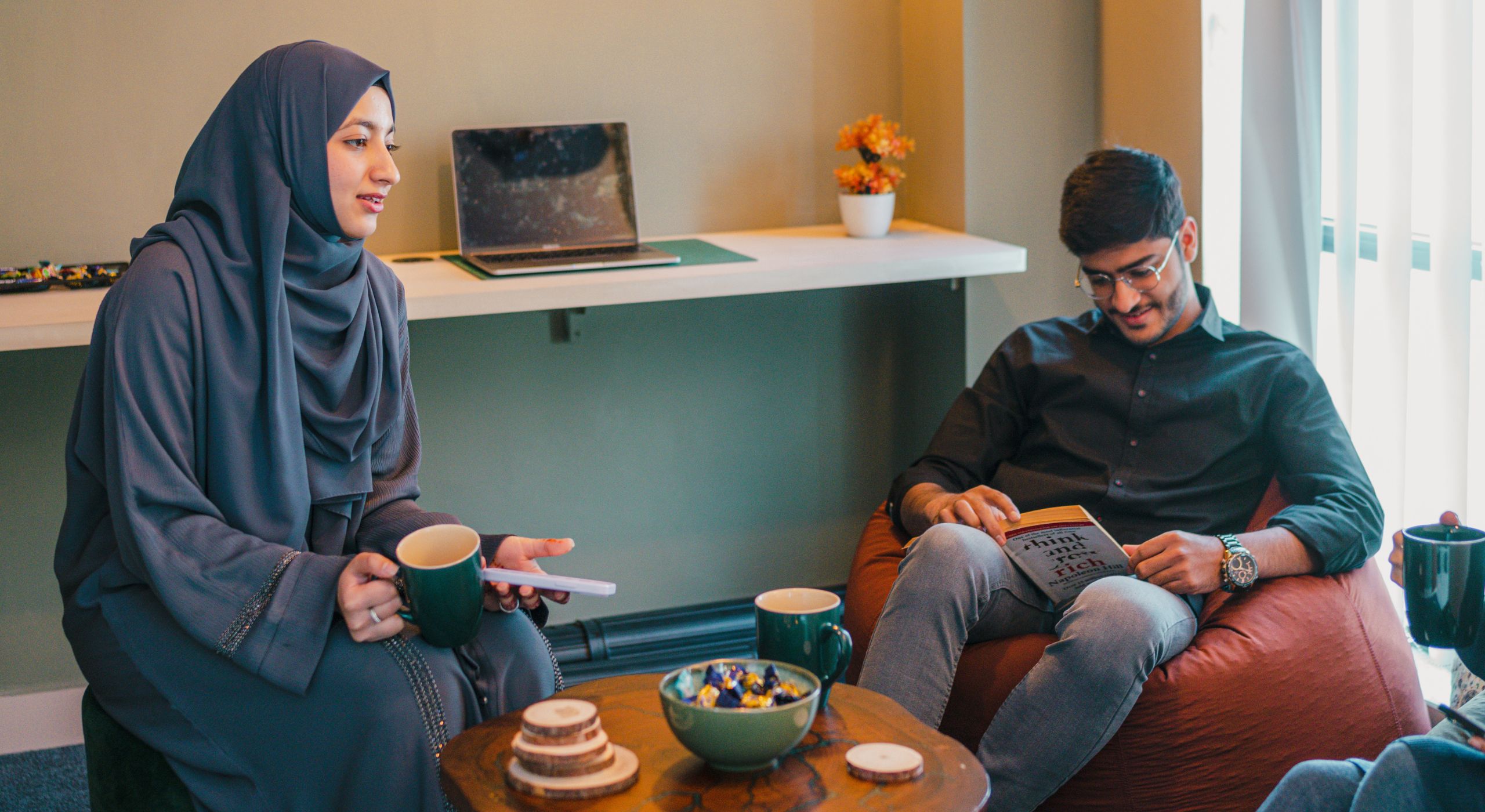 Woman standing at an ENOU backdrop